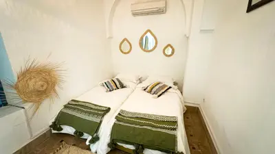 a small bedroom with a bed in a room at Riad Abi in Marrakech
