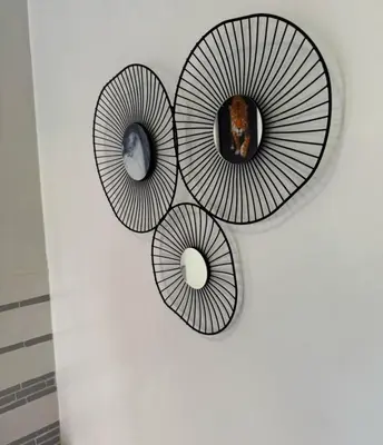 three circular mirrors on a wall in a room at Family apartement at Premium village in Marrakech