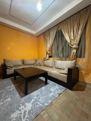 a living room with a couch and a coffee table at Élégance Apartment with 5 swimming pool for family in Marrakech