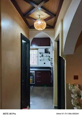 an open door to a kitchen with a chandelier at La nuit est bonne in Marrakech