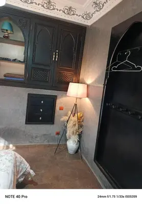 a corner of a room with a lamp and a bedroom at La nuit est bonne in Marrakech