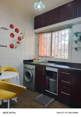 a kitchen with a sink and a washing machine at La nuit est bonne in Marrakech