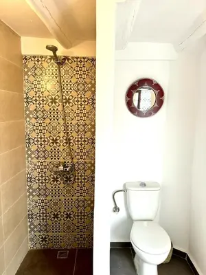 a bathroom with a toilet and a shower at Riad Nabil with Concierge and FREE Breakfast in Marrakech
