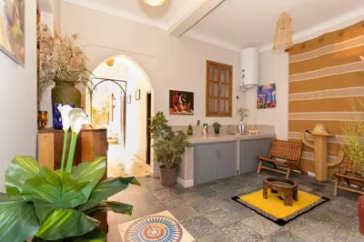 a kitchen with a table and some plants in a room at the old house in Marrakech