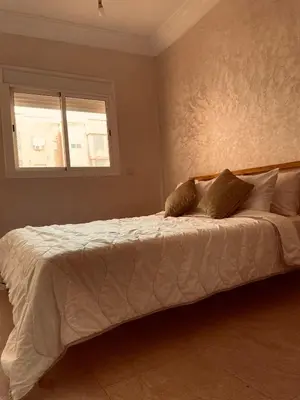 a bedroom with a large white bed with a window at Stylish Appart near the centre in Marrakech