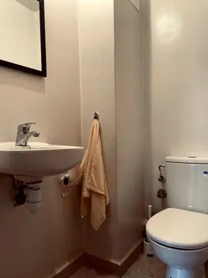 a bathroom with a white toilet and a sink at Stylish Appart near the centre in Marrakech