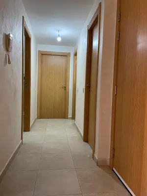 an empty hallway with a door and a tile floor at Stylish Appart near the centre in Marrakech