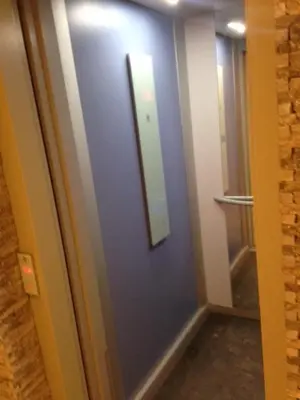 a hallway with a blue door with a mirror at Studio Au Centre Ville Marrakech in Marrakech