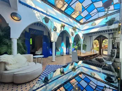 a living room with a glass ceiling and a table at Family villa pool sauna and hammam in Marrakech