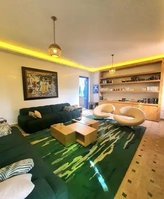 a living room with a couch and a table at Family villa pool sauna and hammam in Marrakech