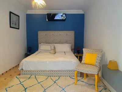a bedroom with a bed with a cat laying on it at Family villa pool sauna and hammam in Marrakech