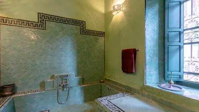 a bathroom with a tub and a sink at Dar Salam Marrakech in Marrakech