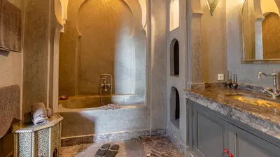 a bathroom with two sinks and a bath tub at Dar Salam Marrakech in Marrakech