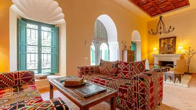 a living room with two couches and a table at Dar Salam Marrakech in Marrakech
