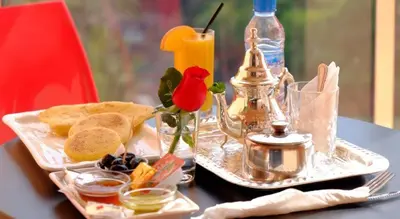 a tray with a plate of food on a table at Marrakxi in Marrakech