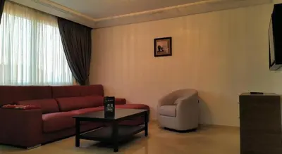 a living room with a couch and a chair at Marrakxi in Marrakech