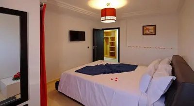 a bedroom with a white bed in a room at Marrakxi in Marrakech