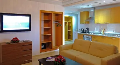 a living room with a couch and a kitchen at Marrakxi in Marrakech