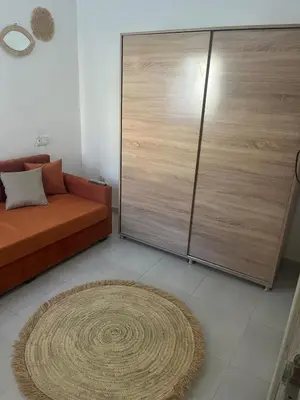 a living room with a couch and a large sliding door at Au cœur de la ville ocre in Marrakech