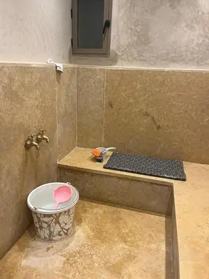 a bathroom with a sink and a bucket in a shower at Akenza hospitality in Marrakech