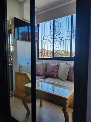 a living room with a couch and a window at MARRAKECH CENTRE Appartement in Marrakech