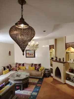 a living room with a couch and a chandelier at Authentic Apartment Riad style in Marrakech in Marrakech