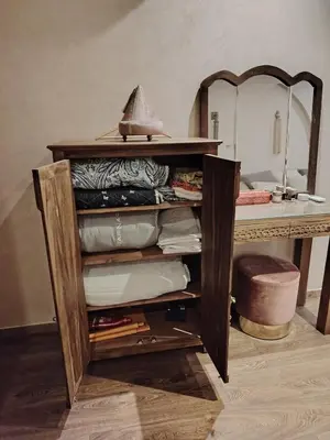 a wooden shelf with a mirror and a table at Authentic Apartment Riad style in Marrakech in Marrakech
