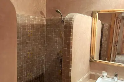 a bathroom with a shower and a sink at Atlas Gardens Apartment in Sraghna