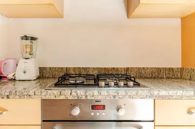 a kitchen counter with a stove and a blender at Prestige authentique in Marrakech