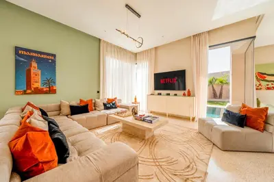 a living room with a couch and a table at Luxury 5-Star Villa - Games & Activities - 15 min to Center in Marrakech