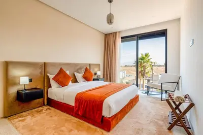a bedroom with a large bed and a large window at Luxury 5-Star Villa - Games & Activities - 15 min to Center in Marrakech