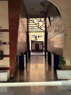 a hallway of a building with an archway and a stage at Authentic Family Apartment Riad stylein Gueliz in Marrakech