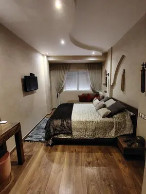 a bedroom with a large bed and a window at Authentic Family Apartment Riad stylein Gueliz in Marrakech