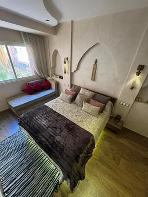 a bedroom with a bed and a couch in it at Authentic Family Apartment Riad stylein Gueliz in Marrakech