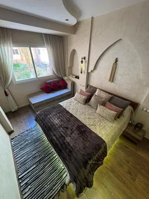 a bedroom with a bed and a couch in it at Authentic Family Apartment Riad stylein Gueliz in Marrakech