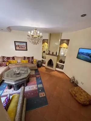a living room with a couch and a fireplace at Authentic Family Apartment Riad stylein Gueliz in Marrakech