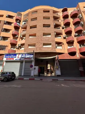 a building with a car parked in front of it at Authentic Family Apartment Riad stylein Gueliz in Marrakech