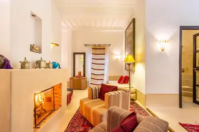 a living room with a couch and a fireplace at Dar Charkia in Marrakech