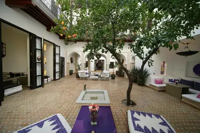 a living room with a purple table and a tree at Dar Charkia in Marrakech