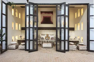 a room with doors and a room with beds at Dar Charkia in Marrakech