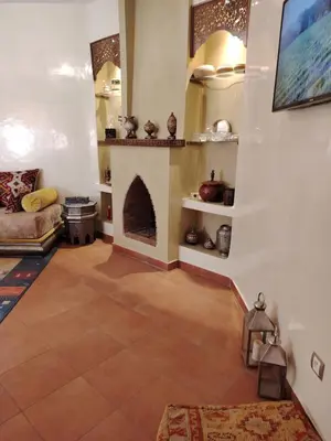 a living room with a fireplace and a couch at Authentic Apartment Riad Style in Gueliz for Family in Marrakech