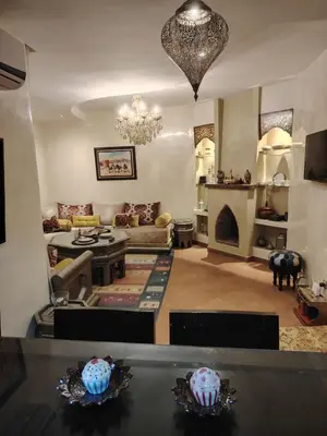 a living room with a couch and a fireplace at Authentic Apartment Riad Style in Gueliz for Family in Marrakech