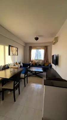 a living room with a couch and a table at Bright with great view in Marrakech