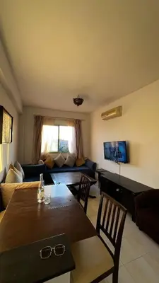 a living room with a table and a couch at Bright with great view in Marrakech