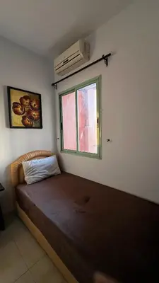 a bedroom with a bed and a window at Bright with great view in Marrakech
