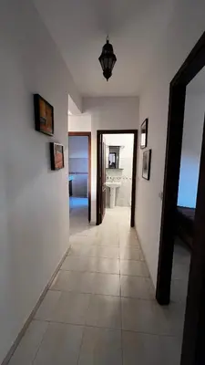 a hallway with white walls and a tile floor at Bright with great view in Marrakech