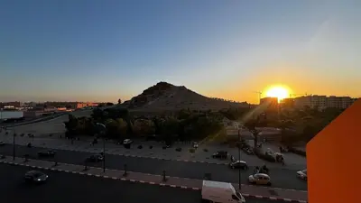 a view of a mountain with the sun setting behind it at Bright with great view in Marrakech
