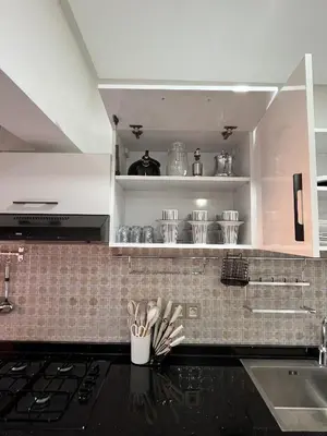 a kitchen with white cabinets and a black counter top at Modern Apartment with Fully Equipped Kitchen Perfect Location in Marrakech in Marrakech