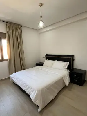 a bedroom with a large white bed and a window at Modern Apartment with Fully Equipped Kitchen Perfect Location in Marrakech in Marrakech