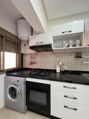 a kitchen with a stove and a washing machine at Modern Apartment with Fully Equipped Kitchen Perfect Location in Marrakech in Marrakech